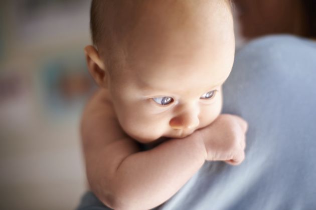 A cute baby in her mother's arms